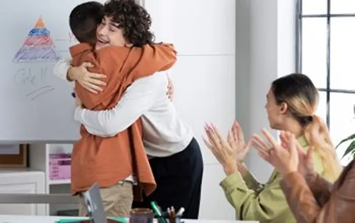 Team gathered around a laptop